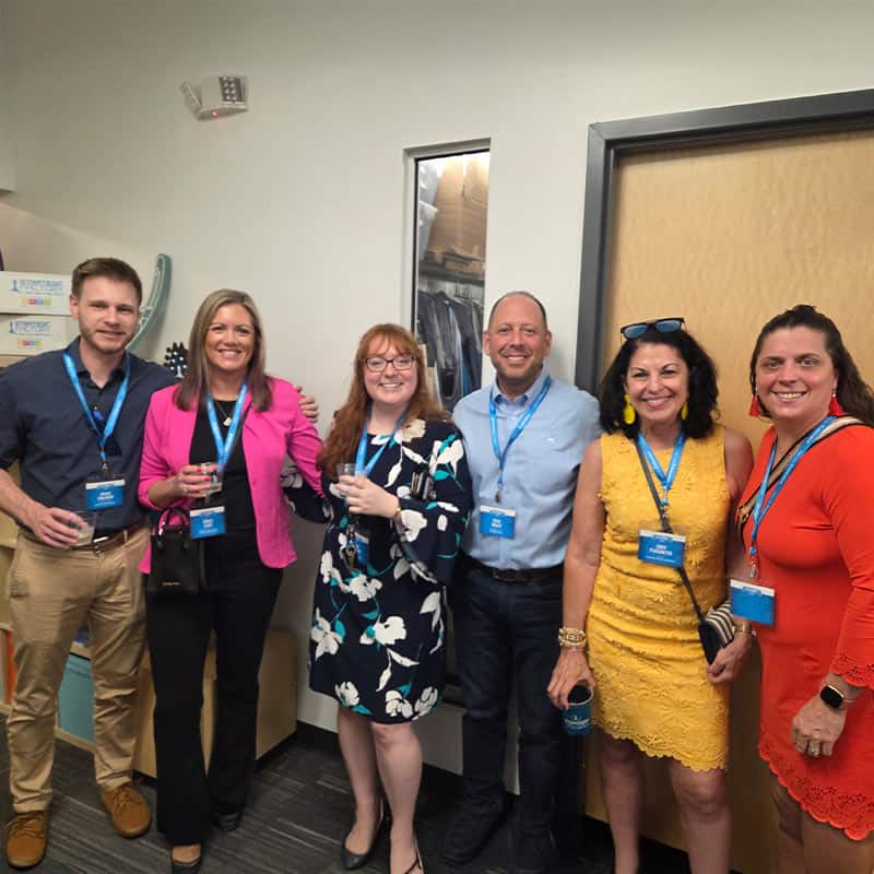 Joshua Tomlinson and Brooke Alosie of Atlantic Graphic Systems, Keith Miller of Strategic Factory, and Cindy Plackmeyer of Cindy Plackmeyer Marketing pose for a picture at networking happy hour.